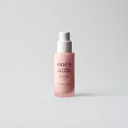 A pink cosmetic pump bottle with a white pump dispenser, featuring the brand name 'ODEN' and product name 'LA CRÊME REPULSANTE' printed on the front, set against a clean light gray background.