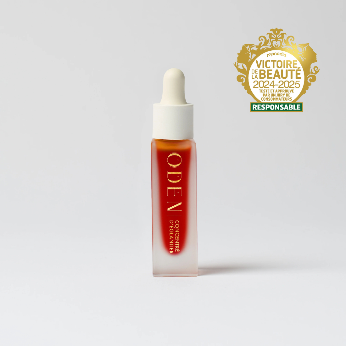 Skincare dropper bottle with 'ODEN' branding on a white background, featuring a gold award logo.